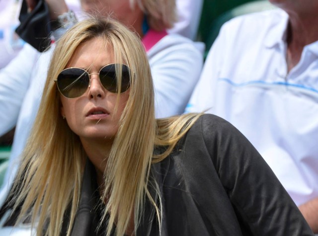 Maria Sharapova of Russia sits on court three to watch Grigor Dimitrov of Bulgaria play Grega Zemlja of Slovenia in their men's singles tennis match at the Wimbledon Tennis Championships, in London