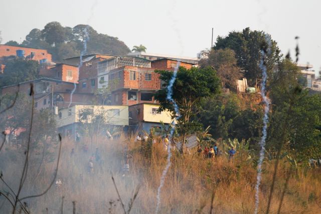 Teargas is seen after it was released near the Santa Cruz slums by the national police trying to disperse an opposition protest near the slums in Caracas