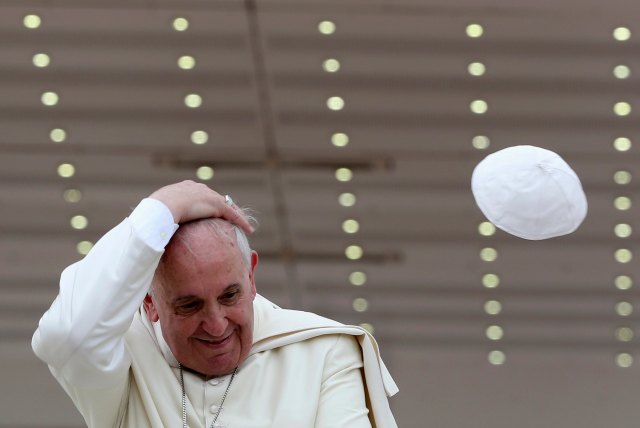 A gust of wind blows off Pope Francis' cap during his weekly general audience at St. Peter's Square at the Vatican