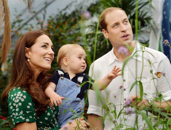 Britain's Catherine, Duchess of Cambridge, carries her son Prince George alongside her husband Prince William as they visit the Sensational Butterflies exhibition at the Natural History Museum in London