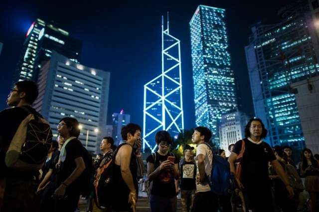 Manifestantes pro democracia en Hong Kong iluminan con sus teléfonos celulares luego de una fuerte lluvia (Foto Philippe Lopez / AFP)