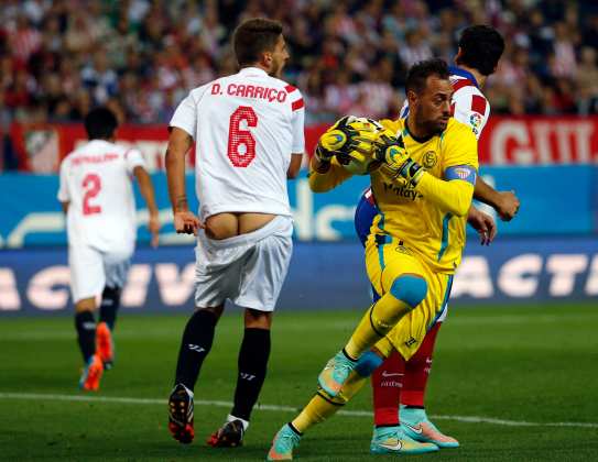 Sevilla's Carrico has his shorts come lose while fighting for the ball during their Spanish first division soccer match against Atletico Madrid in Madrid