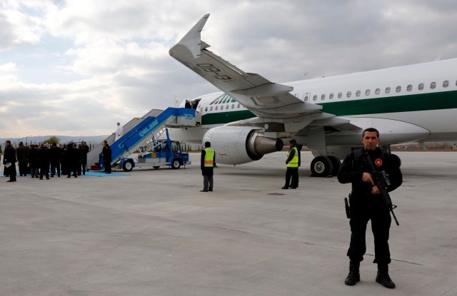 A Turkish policeman watches as Pope Francis arrives in Ankara