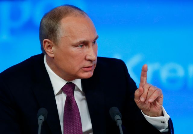 Russian President Putin gestures during his annual end-of-year news conference in Moscow