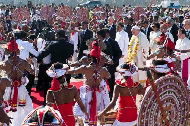 Pope Francis is greeted as he arrives at the Colombo airport