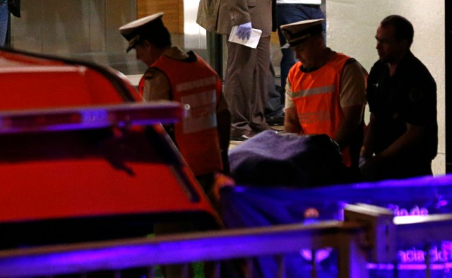 Members of the coast guard carry the body of Argentine prosecutor Alberto Nisman, out of the apartment building where he lives in Buenos Aires