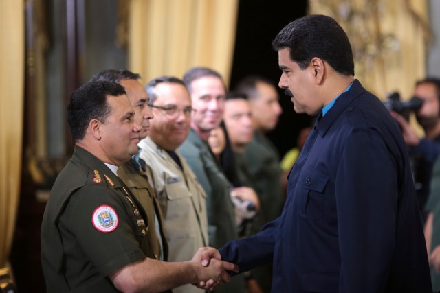 Venezuela's President Nicolas Maduro greets Gustavo Gonzalez as he welcomes army members sanctioned by the U.S. in Caracas