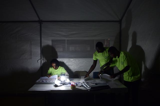 Election officials prepare the ballots for voters in Port-au-Prince, Haiti, on August 9, 2015, during the Legislatives Elections.After nearly four years of delays, Haiti staged legislative elections Sunday in a vote overshadowed by fears of violence and poor turnout. Polling stations opened at 6:00 am (1000 GMT) for the first time since President Michel Martelly came to power in May 2011. The poorest country in the Americas, Haiti suffers from a history of chronic instability and is still struggling to recover from the devastating 2010 earthquake. AFP PHOTO/HECTOR RETAMAL