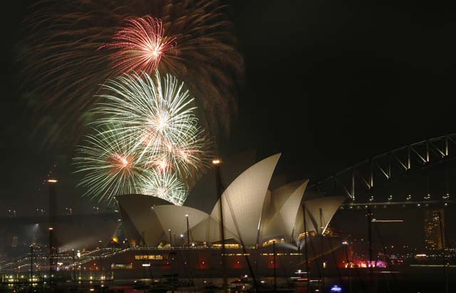 Fireworks explode over the Sydney Opera House in a 9pm display before the midnight fireworks which will usher in the new year in Australia's largest city