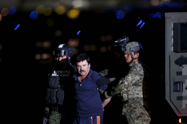 Joaquin "El Chapo" Guzman is escorted by soldiers during a presentation at the hangar belonging to the office of the Attorney General in Mexico City, Mexico January 8, 2016.  REUTERS/Edgard Garrido