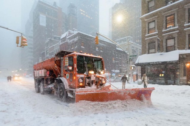 A snowplow clears snow on Lexington Avenue during the snowstorm January 2016 in New York. A deadly blizzard with bone-chilling winds and potentially record-breaking snowfall slammed the eastern US on Saturday, as officials urged millions in the storm's path to seek shelter -- warning the worst is yet to come. / AFP / FRANCOIS XAVIER MARIT