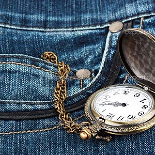 Closeup pocket watch in pocket of jeans