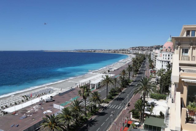 This picture taken on July 15, 2016, shows the site where a truck drove into a crowd watching a fireworks display on the Promenade des Anglais seafront near the Negresco Hotel in the French Riviera town of Nice on July 15, 2016. An attack in Nice where a man rammed a truck into a crowd of people left 84 dead and another 18 in a "critical condition", interior ministry spokesman Pierre-Henry Brandet said Friday. An unidentified gunman barrelled the truck two kilometres (1.3 miles) through a crowd that had been enjoying a fireworks display for France's national day before being shot dead by police.  / AFP PHOTO / Valery HACHE