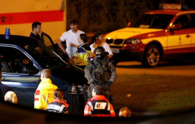 A special force police officer stand guard near the Olympia shopping mall, following a shooting rampage at the mall in Munich, Germany July 23, 2016. REUTERS/Michael Dalder