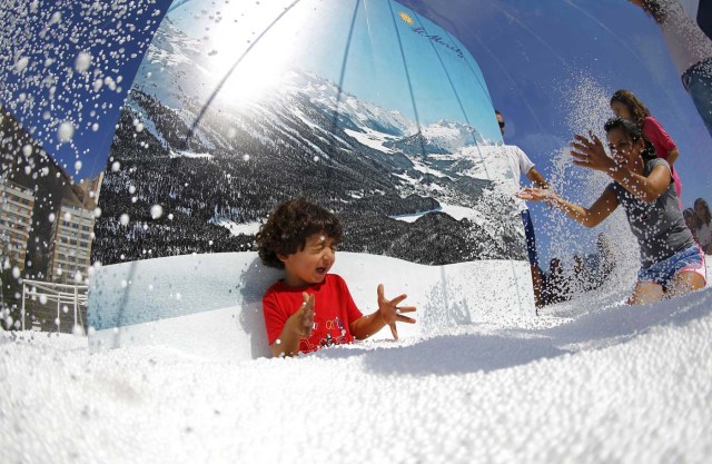 Rio Olympics - Lagoa - Rio de Janeiro, Brazil - 01/08/2016. A boy plays in a display at the Switzerland house. REUTERS/Ivan Alvarado FOR EDITORIAL USE ONLY. NOT FOR SALE FOR MARKETING OR ADVERTISING CAMPAIGNS.