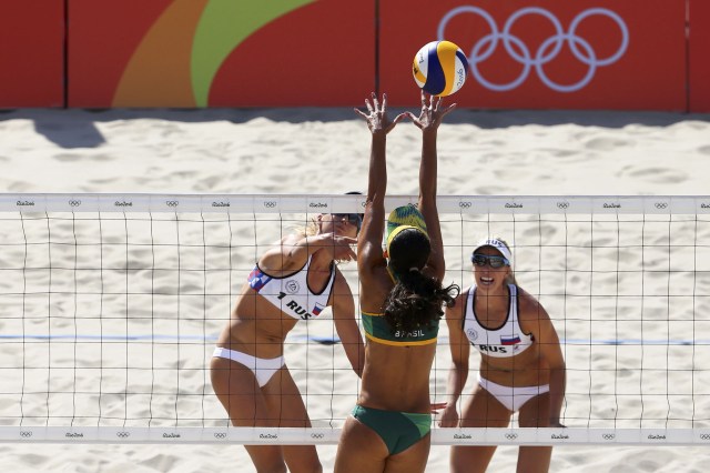 2016 Rio Olympics - Beach Volleyball - Women's Preliminary - Beach Volleyball Arena - Rio de Janeiro, Brazil - 07/08/2016. Evgenia Ukolova (RUS) of Russia and Ekaterina Birlova (RUS) of Russia challenge Talita (BRA) of Brazil. REUTERS/Ruben Sprich FOR EDITORIAL USE ONLY. NOT FOR SALE FOR MARKETING OR ADVERTISING CAMPAIGNS.