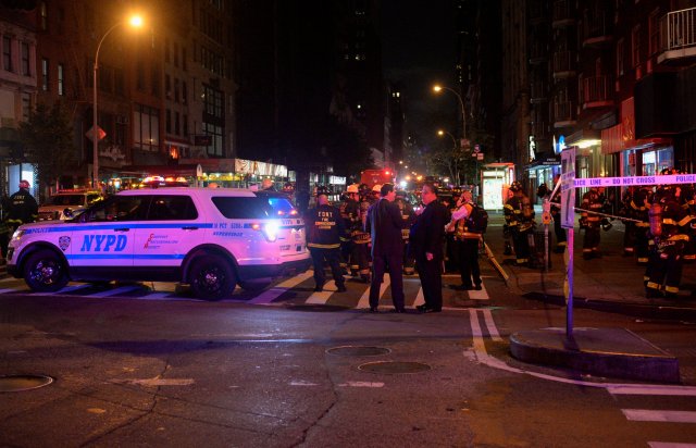 New York City police and firefighters stand near the site of an explosion in the Chelsea neighborhood of Manhattan, New York, U.S. September 17, 2016. REUTERS/Rashid Umar Abbasi