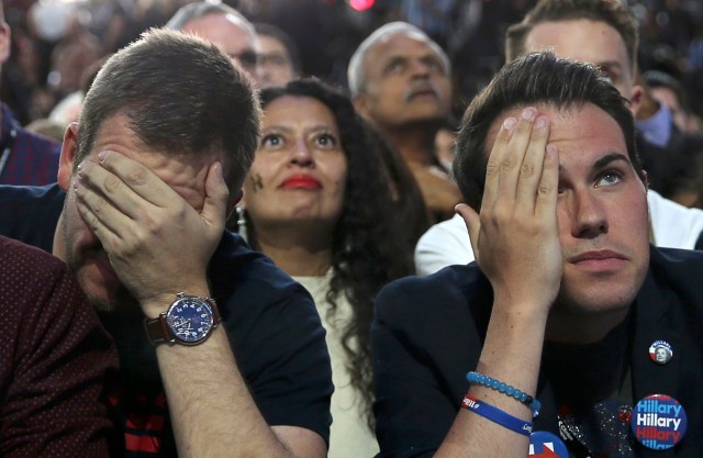 Supporters of Democratic presidential nominee Hillary Clinton watch and wait at her election night rally in New York, U.S., November 8, 2016. REUTERS/Carlos Barria