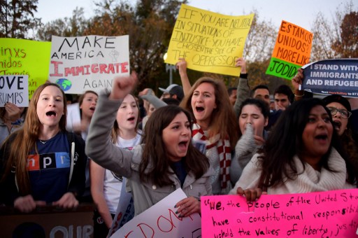 Anti President-elect Donald Trump protesters chant outside the White House in Washington, DC, November 10, 2016. Protesters burned a giant orange-haired head of Donald Trump in effigy, lit fires in the streets and blocked traffic as rage over the billionaire's election victory spilled onto the streets of major US cities. / AFP PHOTO / JIM WATSON