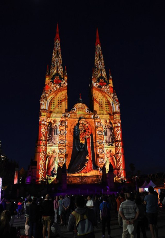 St Mary's Cathedral is illuminated with a Christmas-themed projection in Sydney to celebrate the Christmas season on December 9, 2016. / AFP PHOTO / SAEED KHAN