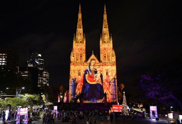 St Mary's Cathedral is illuminated with a Christmas-themed projection in Sydney to celebrate the Christmas season on December 9, 2016. / AFP PHOTO / SAEED KHAN