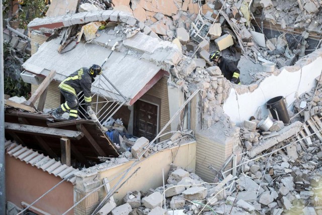 ITA01 ROMA (ITALIA), 28/12/2016.- Varios bomberos trabajan entre los escombros de un edificio colapsado en Acilia, Italia, hoy 28 de diciembre de 2016. Al menos dos personas fueron rescatadas de un edificio hundido tras una fuga de gas. EFE/Massimo Percossi