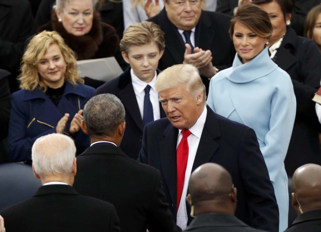 President-elect Donald Trump talks with outgoing President Barack Obama during inauguration ceremonies on the West front of the U.S. Capitol in Washington, U.S., January 20, 2017. REUTERS/Kevin Lamarque