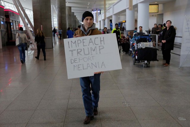 A protester walks through Terminal 4 at John F. Kennedy International Airport in Queens, New York, U.S., January 28, 2017.  REUTERS/Andrew Kelly