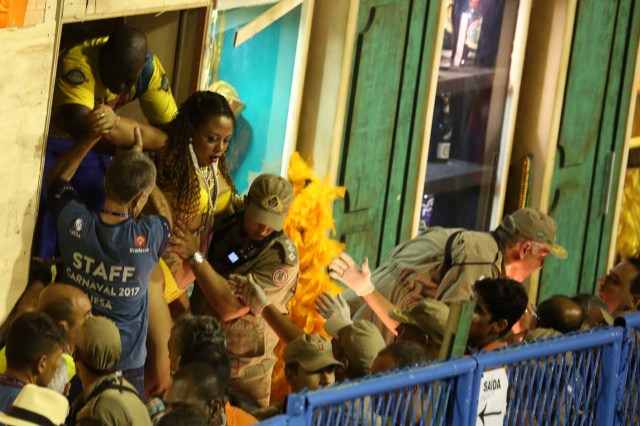 A reveller is assisted after an accident with a float from Unidos da Tijuca samba school during the second night of the carnival parade at the Sambadrome in Rio de Janeiro, Brazil, February 28, 2017.   REUTERS/Pilar Olivares