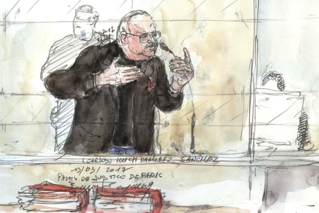 A court sketch made on March 13, 2017 shows Ilyich Ramirez Sanchez, known as  Carlos the Jackal, gesturing during his trial in France for the deadly bombing of the Drugstore Publicis, a busy shop once located in Saint-Germain-des-Pres in the French capital Paris more than 40 years ago.  Carlos, 67, a Venezuelan whose real name is Ilyich Ramirez Sanchez was arrested in the Sudanese capital Khartoum in 1994 by elite French police. He is already serving a life sentence for the murders of two policemen killed in Paris in 1975 and that of a Lebanese revolutionary. He was also found guilty of four bombings in Paris and Marseille in 1982 and 1983, some targeting trains, which killed a total of 11 people and injured nearly 150.  / AFP PHOTO / Benoit PEYRUCQ