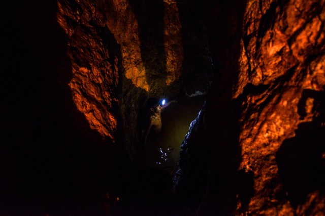 Ender Moreno looks for gold at La Culebra gold mine in El Callao, Bolivar state, southeastern Venezuela on March 1, 2017. Although life in the mines of eastern Venezuela is hard and dangerous, tens of thousands from all over the country head for the mines daily in overcrowded trucks, pushed by the rise in gold prices and by the severe economic crisis affecting the country, aggravated recently by the drop in oil prices. / AFP PHOTO / JUAN BARRETO / TO GO WITH AFP STORY by Maria Isabel SANCHEZ