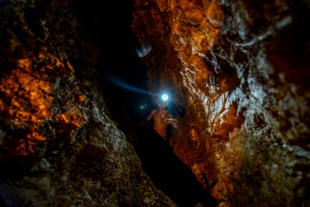 Ender Moreno looks for gold at La Culebra gold mine in El Callao, Bolivar state, southeastern Venezuela on March 1, 2017. Although life in the mines of eastern Venezuela is hard and dangerous, tens of thousands from all over the country head for the mines daily in overcrowded trucks, pushed by the rise in gold prices and by the severe economic crisis affecting the country, aggravated recently by the drop in oil prices. / AFP PHOTO / JUAN BARRETO / TO GO WITH AFP STORY by Maria Isabel SANCHEZ