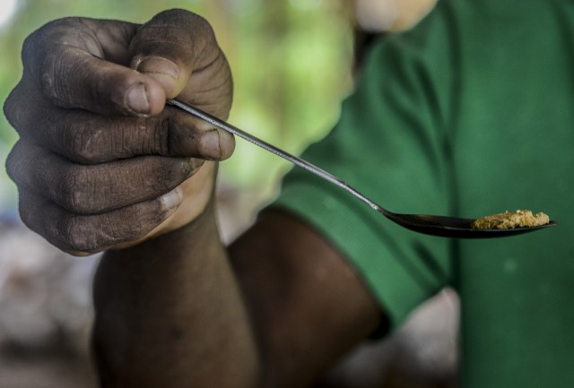 Jorge Sanchez, 24, shows a gold stone at a gold mine in El Callao, Bolivar state, southeastern Venezuela on February 25, 2017. Although life in the mines of eastern Venezuela is hard and dangerous, tens of thousands from all over the country head for the mines daily in overcrowded trucks, pushed by the rise in gold prices and by the severe economic crisis affecting the country, aggravated recently by the drop in oil prices. / AFP PHOTO / JUAN BARRETO