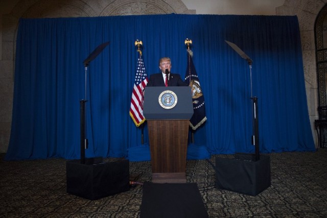 US President Donald Trump delivers a statement on Syria from the Mar-a-Lago estate in West Palm Beach, Florida, on April 6, 2017. Trump ordered a massive military strike against a Syria Thursday in retaliation for a chemical weapons attack they blame on President Bashar al-Assad. A US official said 59 precision guided missiles hit Shayrat Airfield in Syria, where Washington believes Tuesday's deadly attack was launched.  / AFP PHOTO / JIM WATSON