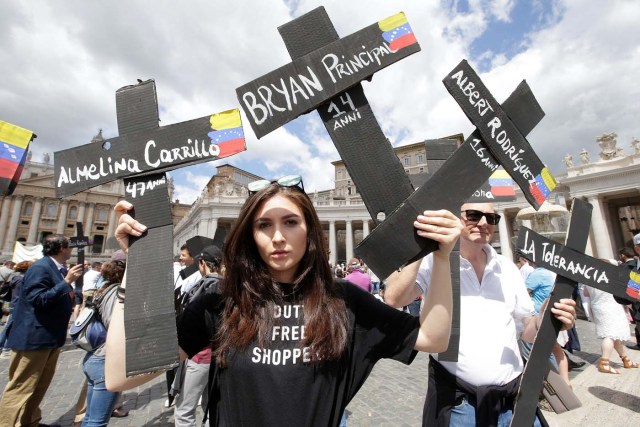 The faithful from Venezuela hold crosses with names of people who died during protests in Venezuela, before the Regina Coeli prayer led by Pope Francis in Saint Peter's Square at the Vatican May 7, 2017. REUTERSMax Rossi