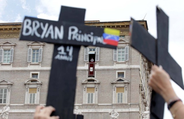 The faithful from Venezuela hold crosses with names of people who died during protests in Venezuela, before the Regina Coeli prayer led by Pope Francis in Saint Peter's Square at the Vatican May 7, 2017. REUTERSMax Rossi