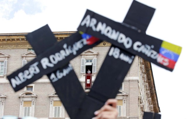 The faithful from Venezuela hold crosses with names of people who died during protests in Venezuela, before the Regina Coeli prayer led by Pope Francis in Saint Peter's Square at the Vatican May 7, 2017. REUTERSMax Rossi