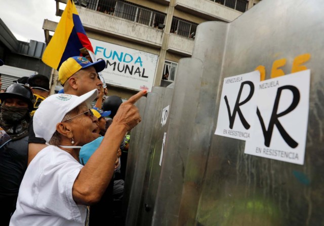 Elderly opposition supporters confront riot security forces while rallying against President Nicolas Maduro in Caracas, Venezuela, May 12, 2017. REUTERS/Carlos Garcia Rawlins