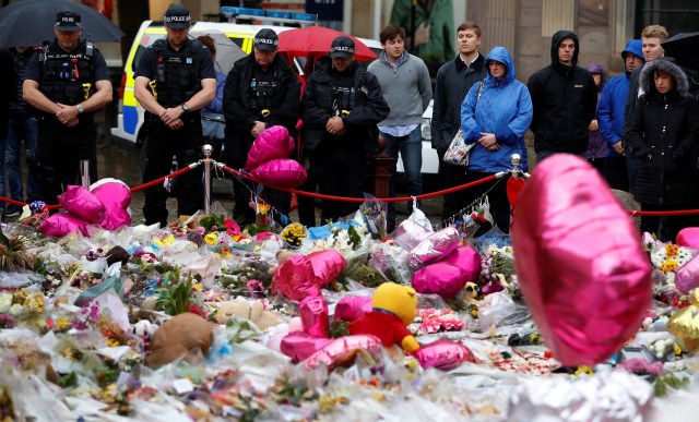 Armed police officers join members of the public to observe a minute's silence for the victims of the attack on London Bridge and Borough Market in St Anne's Square, Manchester, Britain, June 6, 2017. REUTERS/Phil Noble