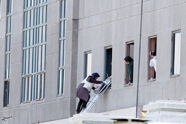 A woman is evacuated during an attack on the Iranian parliament in central Tehran, Iran, June 7, 2017. Tasnim News Agency/Handout via REUTERS ATTENTION EDITORS - THIS PICTURE WAS PROVIDED BY A THIRD PARTY. FOR EDITORIAL USE ONLY. NO RESALES. NO ARCHIVE.