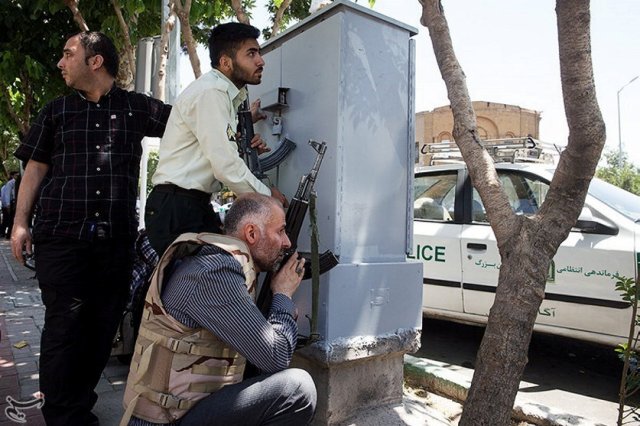 Members of Iranian forces take cover during an attack on the Iranian parliament in central Tehran, Iran, June 7, 2017. Tasnim News Agency/Handout via REUTERS ATTENTION EDITORS - THIS PICTURE WAS PROVIDED BY A THIRD PARTY. FOR EDITORIAL USE ONLY. NO RESALES. NO ARCHIVE.