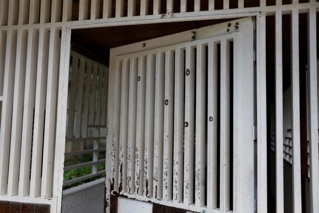 A gate shows remain of destruction caused during a raid of Venezuelan security forces, according to residents, in an apartment complex of Los Teques, Venezuela, July 14, 2017. Picture taken July 14, 2017. REUTERS/Andres Martinez Casares