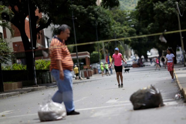 A child is seen jumping rope after a strike called to protest against Venezuelan President Nicolas Maduro's government in Caracas, Venezuela, July 29, 2017. REUTERS/Ueslei Marcelino