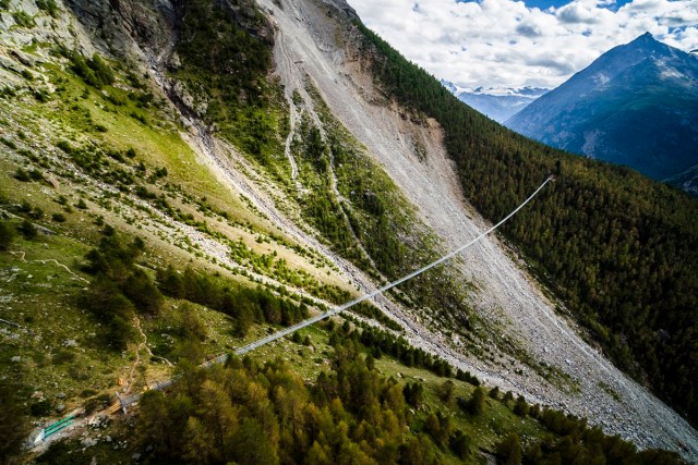 The "Europabruecke",  supposed to be the world's longest pedestrian suspension bridge with a length of 494m, is pictured one day prior to the official inauguration of the construction, in Randa, Switzerland, on Friday, July 28, 2017. The bridge is situated on the Europaweg, that connects the villages of Zermatt and Graechen. (Valentin Flauraud/Keystone via AP)