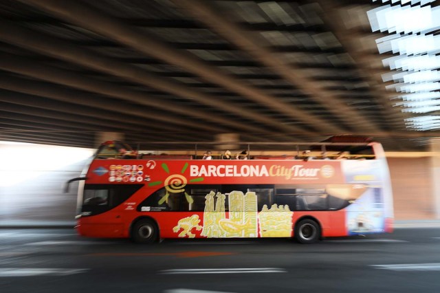 A touristic bus of Barcelona passes under a tunnel in Barcelona on August 21, 2017. Spanish police said on August 21, 2017 that they have identified the driver of the van that mowed down pedestrians on the busy Las Ramblas boulevard in Barcelona, killing 13. The 22-year-old Moroccan is believed to be the last remaining member of a 12-man cell still at large in Spain or abroad, with the others killed by police or detained over last week's twin attacks in Barcelona and the seaside resort of Cambrils that claimed 14 lives, including a seven-year-old boy. / AFP PHOTO / Josep LAGO