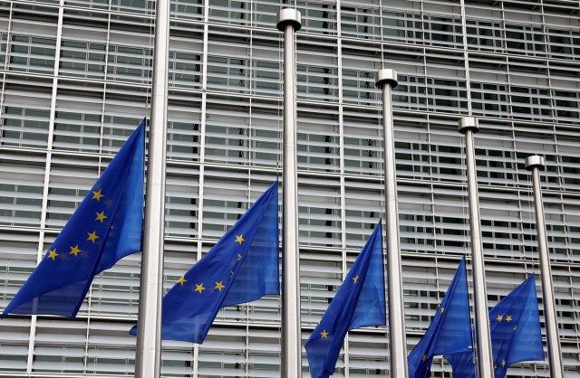 European Union flags are lowered at half-mast in honor of the victims of the Barcelona attack, outside the European Commission headquarters in Brussels, Belgium August 18, 2017. REUTERS/Francois Lenoir