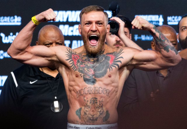 UFC lightweight champion Conor McGregor of Ireland poses on the scale during his official weigh-in at T-Mobile Arena in Las Vegas, Nevada, U.S. on August 25, 2017. REUTERS/Steve Marcus