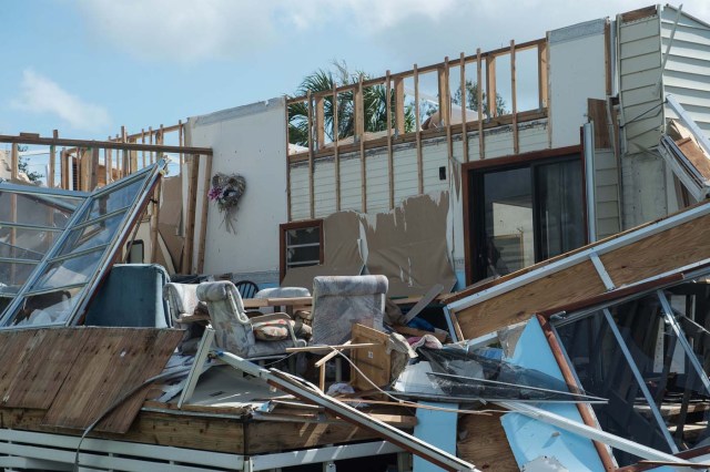 A damaged house is seen in a flooded street at the Enchanted Shores manufactured home park in Naples, Florida, on September 11, 2017 after Hurricane Irma hit Florida. / AFP PHOTO / NICHOLAS KAMM