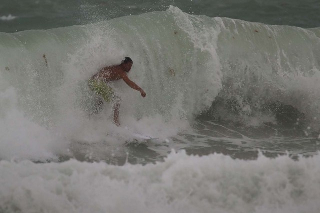 MIAMI BEACH, FL - SEPTEMBER 09: 09: A surfer enjoys the waves as people in the area feel the early arrival of Hurricane Irma on September 9, 2017 in Miami Beach, Florida. Florida is in the path of the Hurricane which may come ashore at category 4.   Joe Raedle/Getty Images/AFP