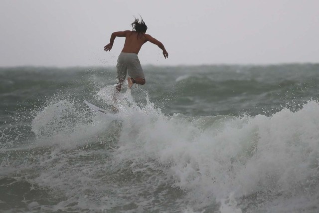 MIAMI BEACH, FL - SEPTEMBER 09: A surfer enjoys the waves churned up buy the approaching Hurricane Irma on September 9, 2017 in Miami Beach, Florida. Florida is in the path of the Hurricane which may come ashore at category 4.   Joe Raedle/Getty Images/AFP